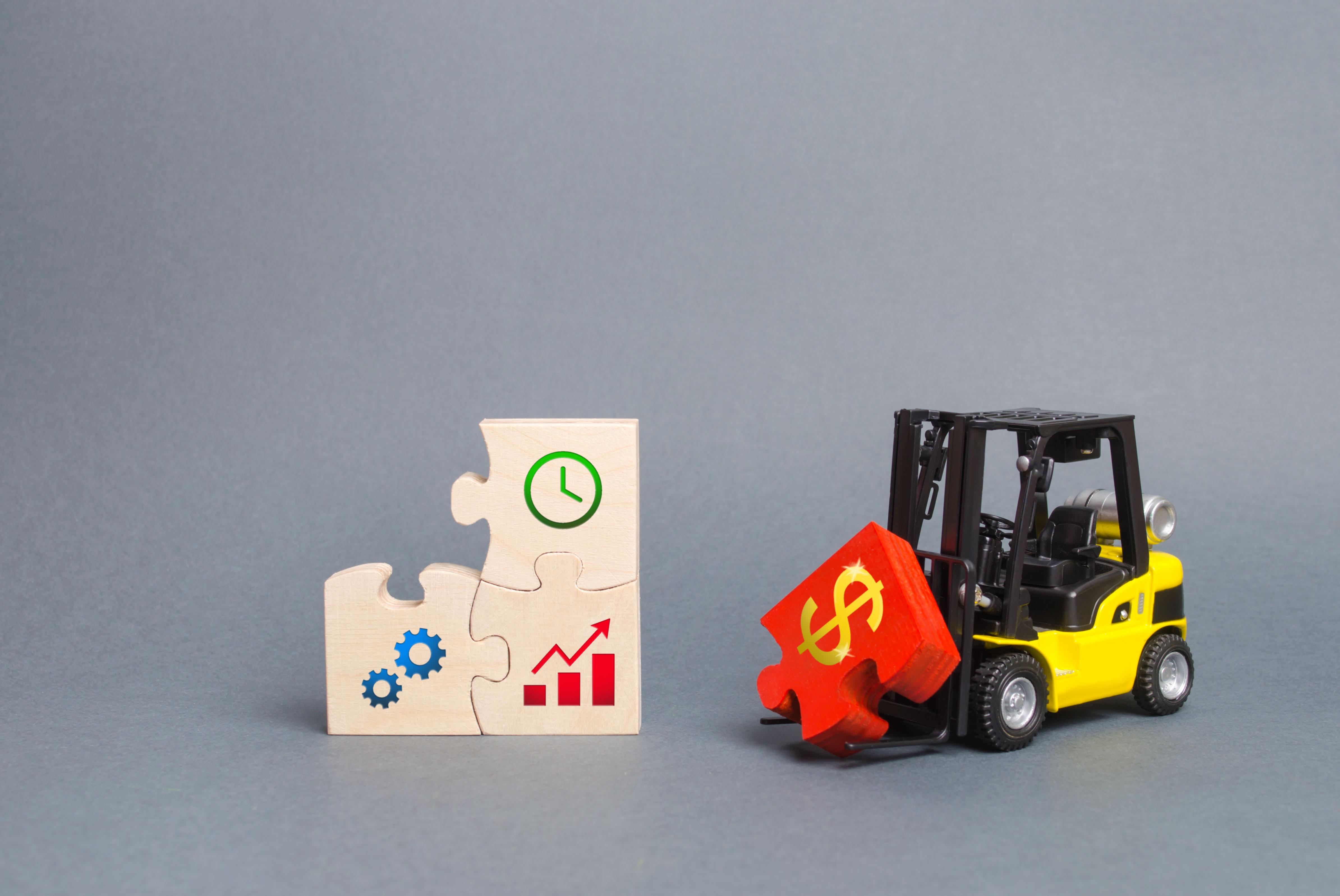 Picture of a forklift carrying a money sign
